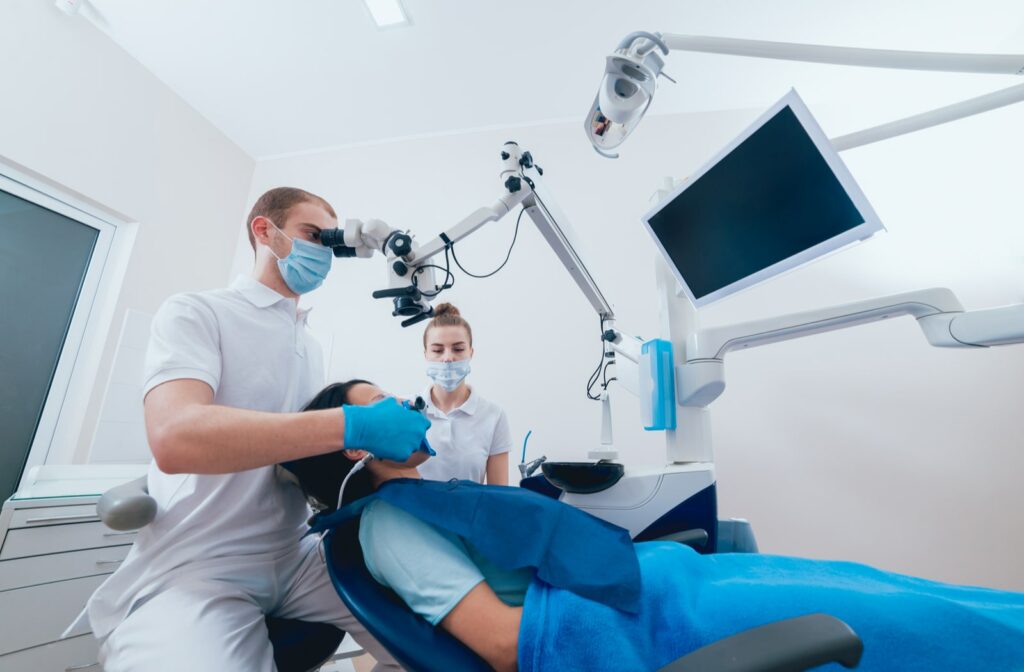A dentist and dental hygienist prepping a patient for root canal treatment