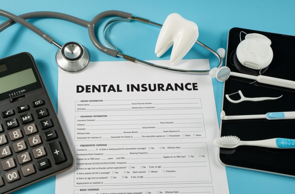 A dental insurance form on a table surrounded by oral hygiene equipment. 