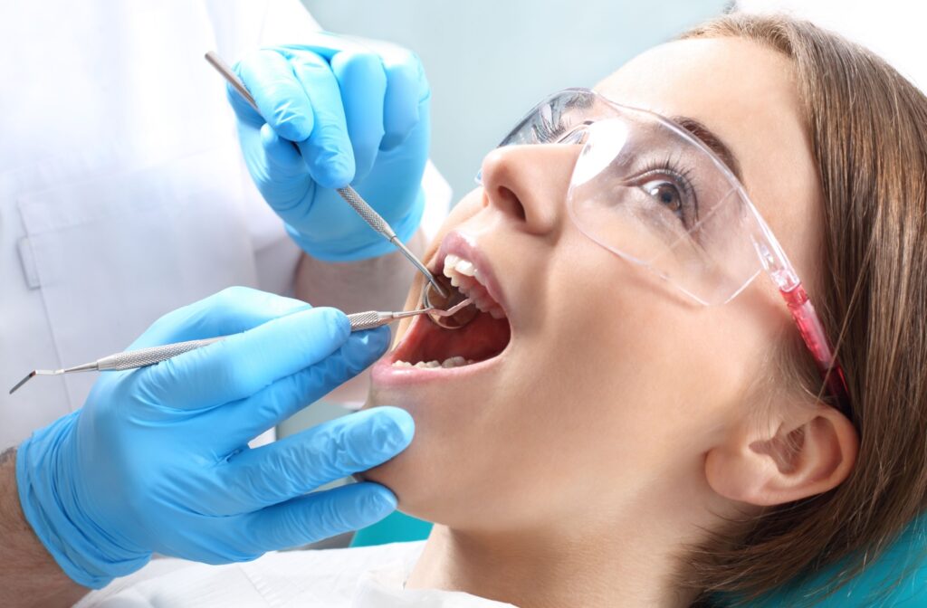A close up of a patient getting a cavity filled at the dentist.